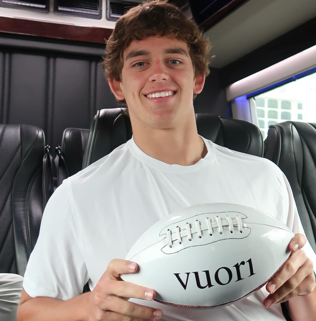 Arch Manning holding a Vuori branded football