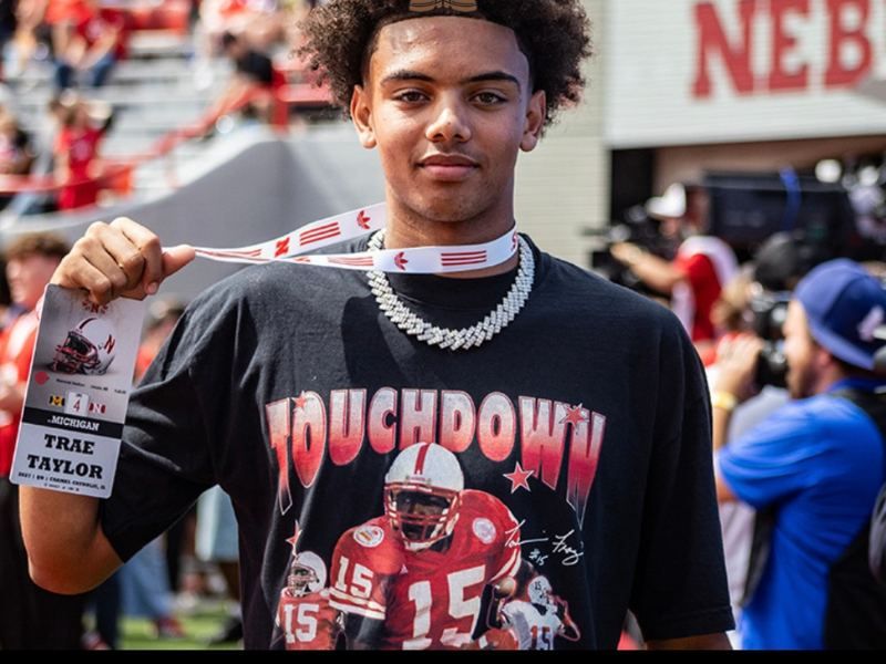 Trae Taylor holding Touchdown tee at Nebraska