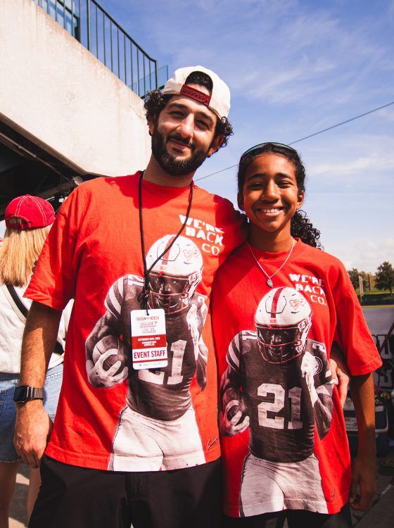 Mark David and daughter Stella at Nebraska gameday tailgate wearing WBC merch